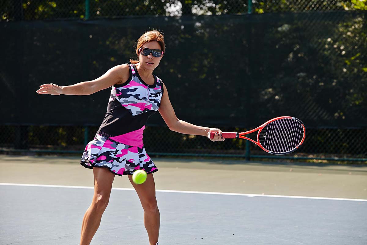 woman playing tennis at the Woodlands Country Club